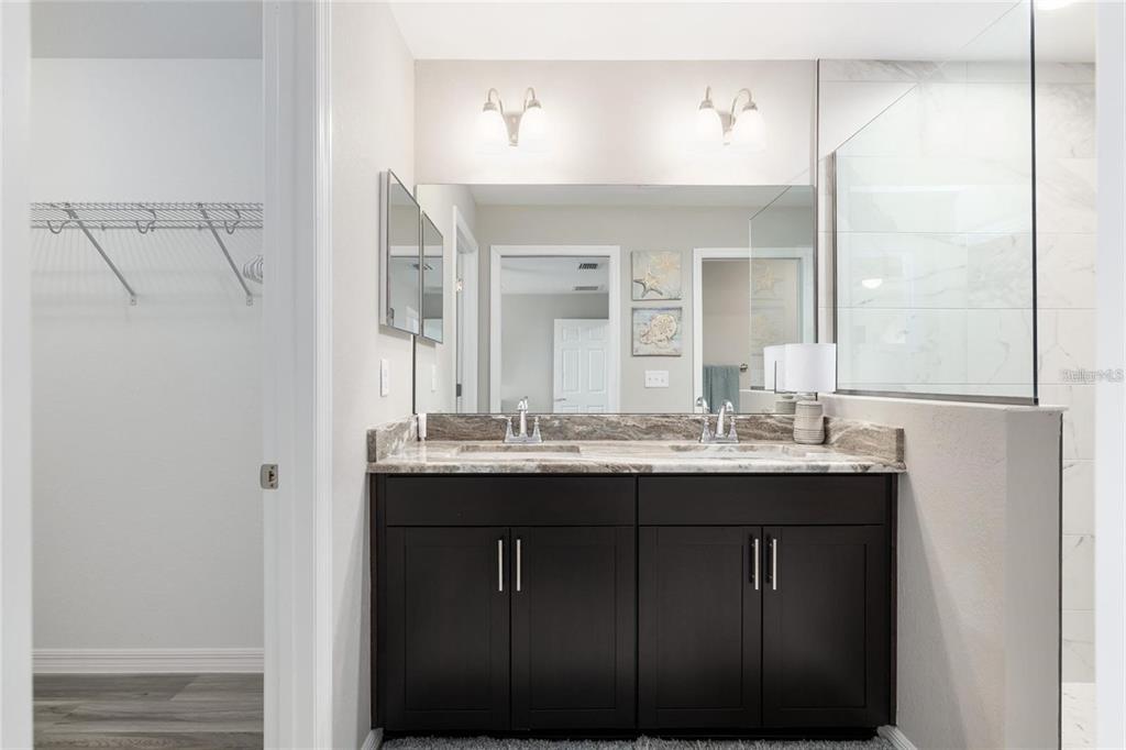 9947 Southeast 117th Street Road Belleview, FL 34420 - Photo 29 of 44 a bathroom with a granite countertop sink and a mirror