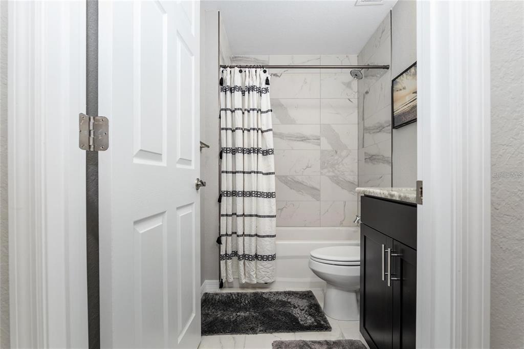 9947 Southeast 117th Street Road Belleview, FL 34420 - Photo 33 of 44 a bathroom with a toilet and a shower