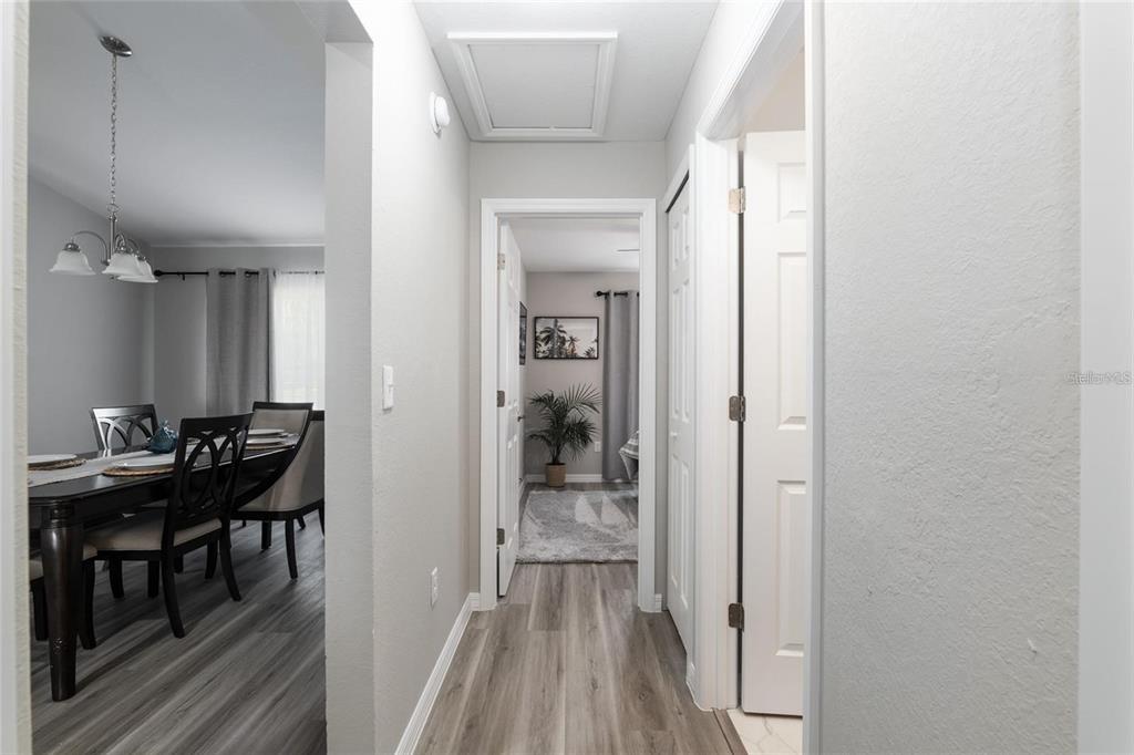 9947 Southeast 117th Street Road Belleview, FL 34420 - Photo 34 of 44 a view of a hallway view with furniture and wooden floor