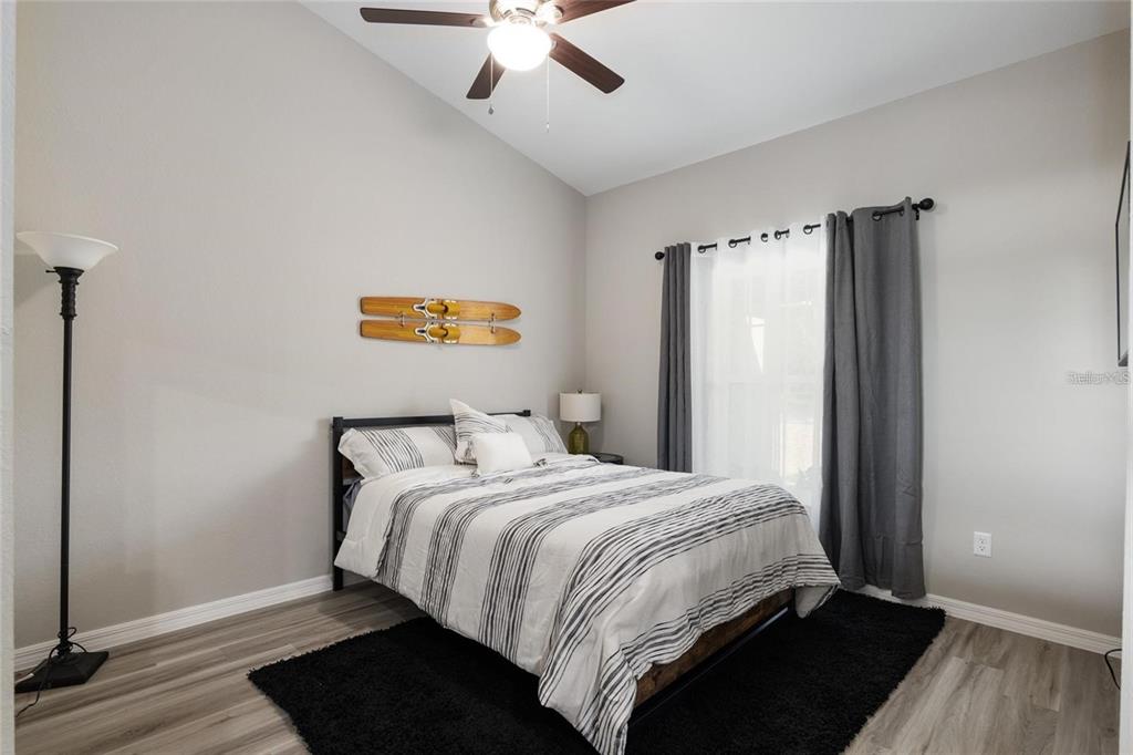 9947 Southeast 117th Street Road Belleview, FL 34420 - Photo 36 of 44 a bedroom with a bed and a window