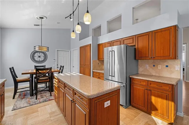 a kitchen with stainless steel appliances granite countertop a sink a stove and a refrigerator