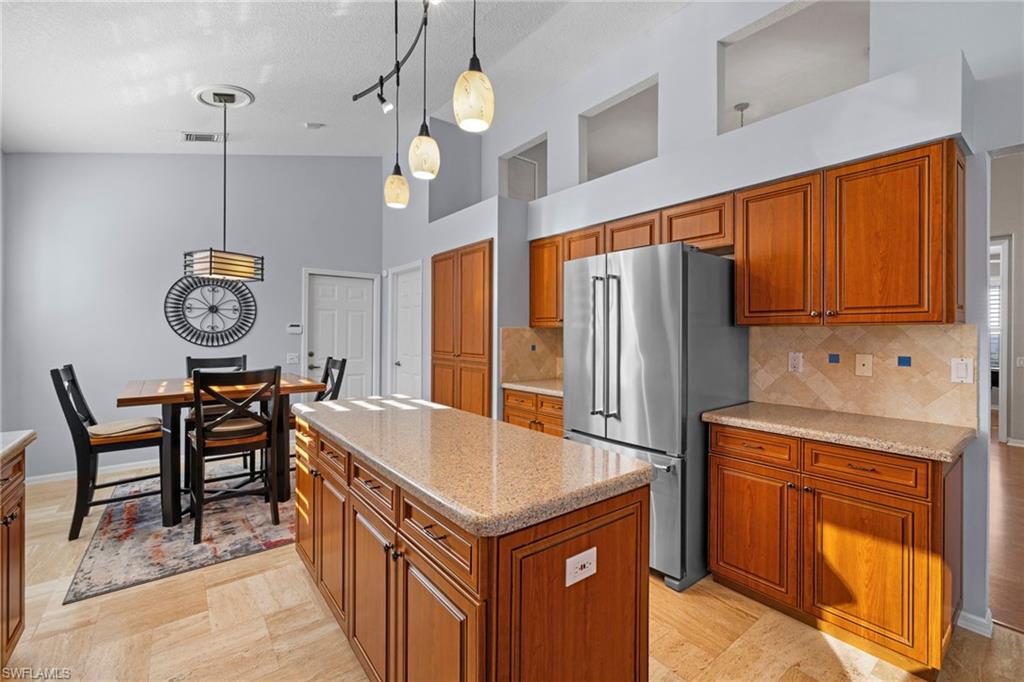 1845 Pondside Lane Naples, FL 34109 - Photo 22 of 47 a kitchen with stainless steel appliances granite countertop a sink a stove and a refrigerator