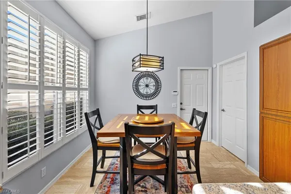 a dining room with furniture and window