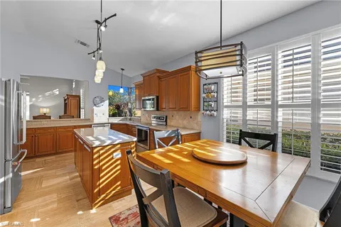 a view of a dining room with furniture and window