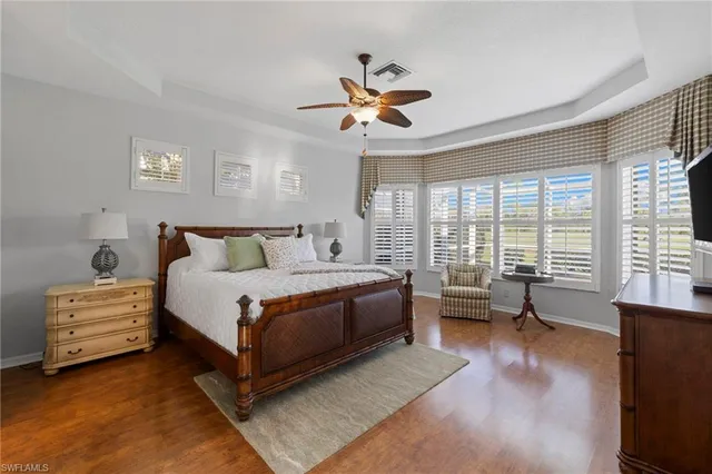 a bedroom with a bed and a large window