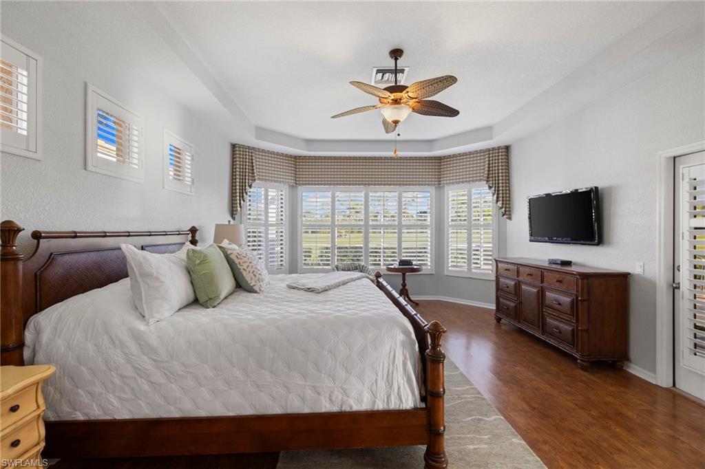 1845 Pondside Lane Naples, FL 34109 - Photo 26 of 47 a bedroom with a bed and a flat screen tv