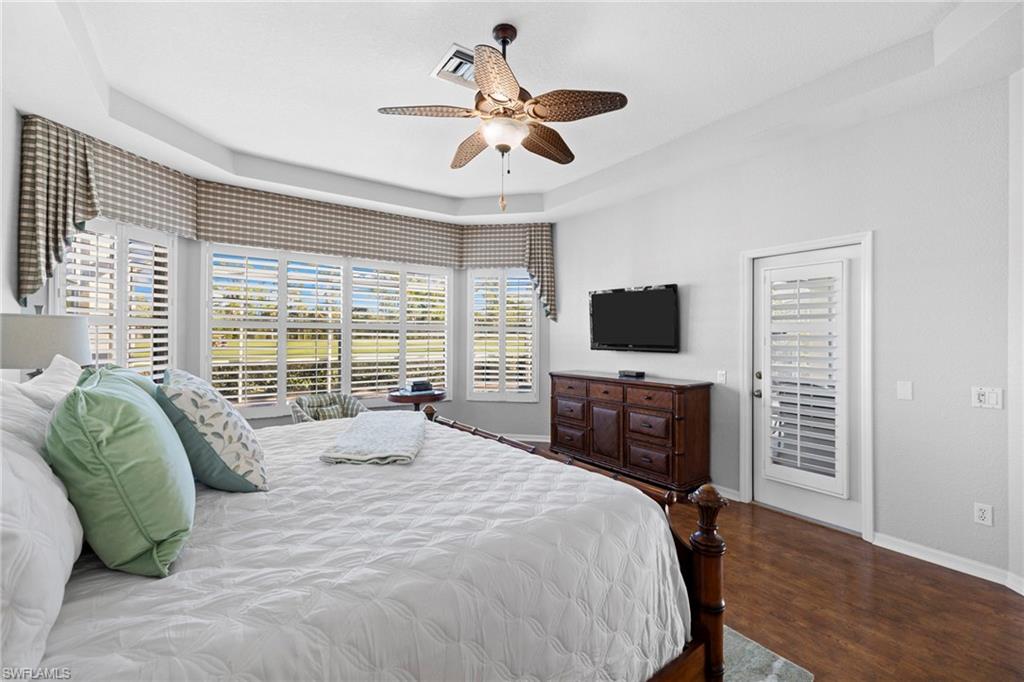 1845 Pondside Lane Naples, FL 34109 - Photo 27 of 47 a bedroom with a bed flat screen tv and a large window