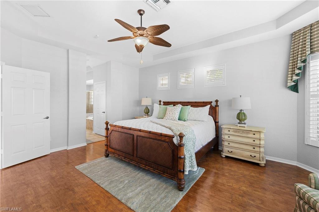 1845 Pondside Lane Naples, FL 34109 - Photo 28 of 47 a bedroom with a bed and a chandelier