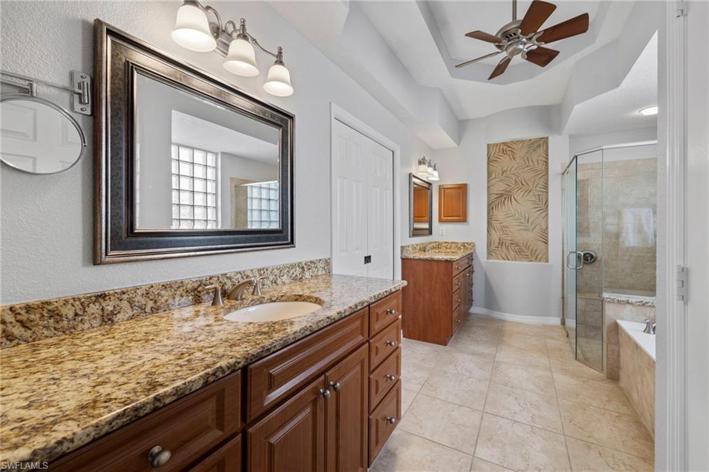 1845 Pondside Lane Naples, FL 34109 - Photo 29 of 47 a bathroom with a granite countertop sink mirror and bathtub