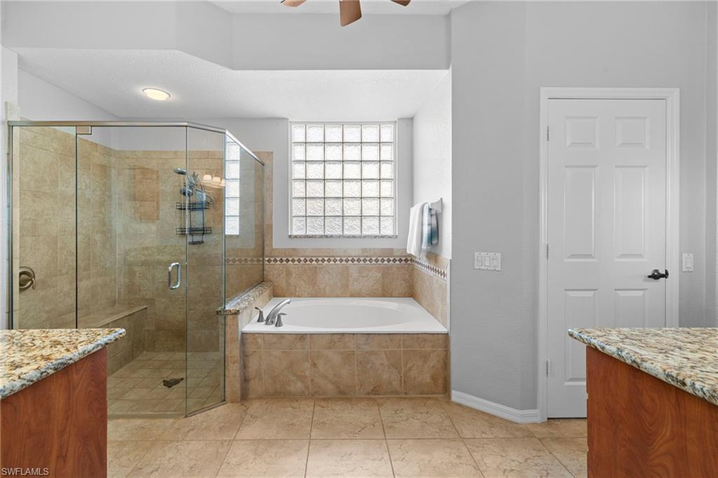 1845 Pondside Lane Naples, FL 34109 - Photo 30 of 47 a bathroom with a granite countertop tub shower and sink