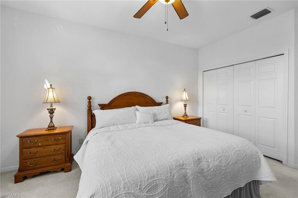 1845 Pondside Lane Naples, FL 34109 - Photo 33 of 47 a bedroom with a bed and a dresser