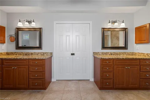 a bathroom with a sink vanity and mirror