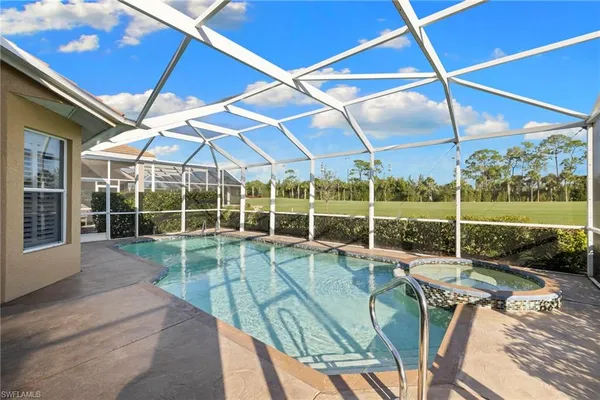 a view of a backyard with a patio and a yard
