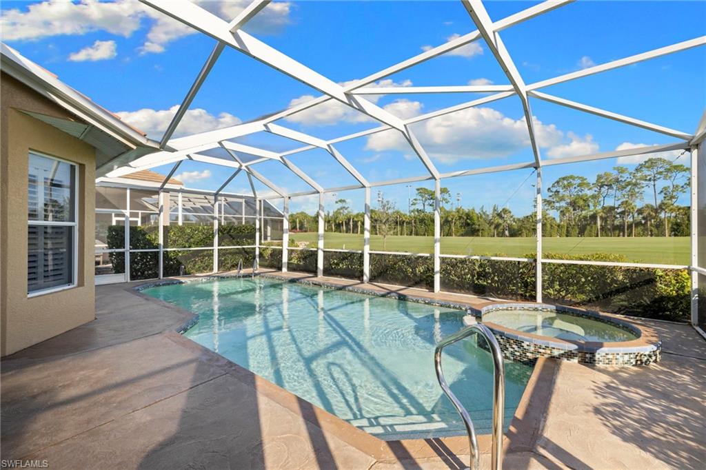 1845 Pondside Lane Naples, FL 34109 - Photo 39 of 47 a view of a backyard with a patio and a yard