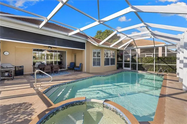 a view of a backyard with swimming pool