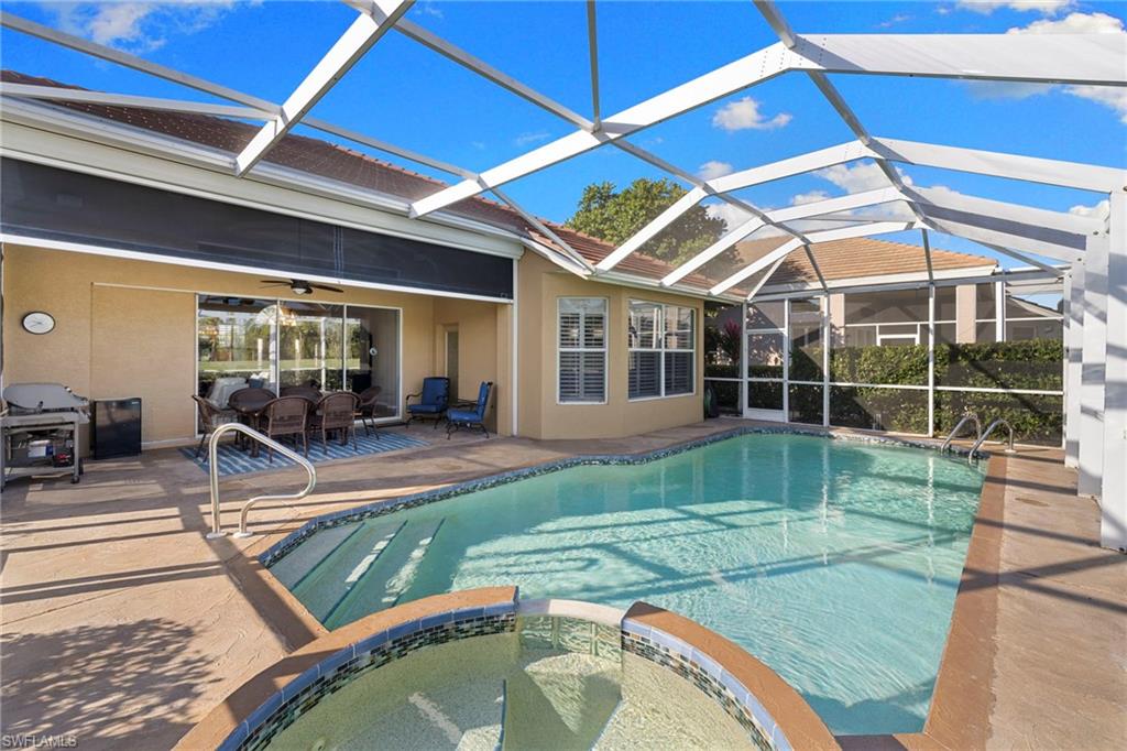 1845 Pondside Lane Naples, FL 34109 - Photo 40 of 47 a view of a backyard with swimming pool