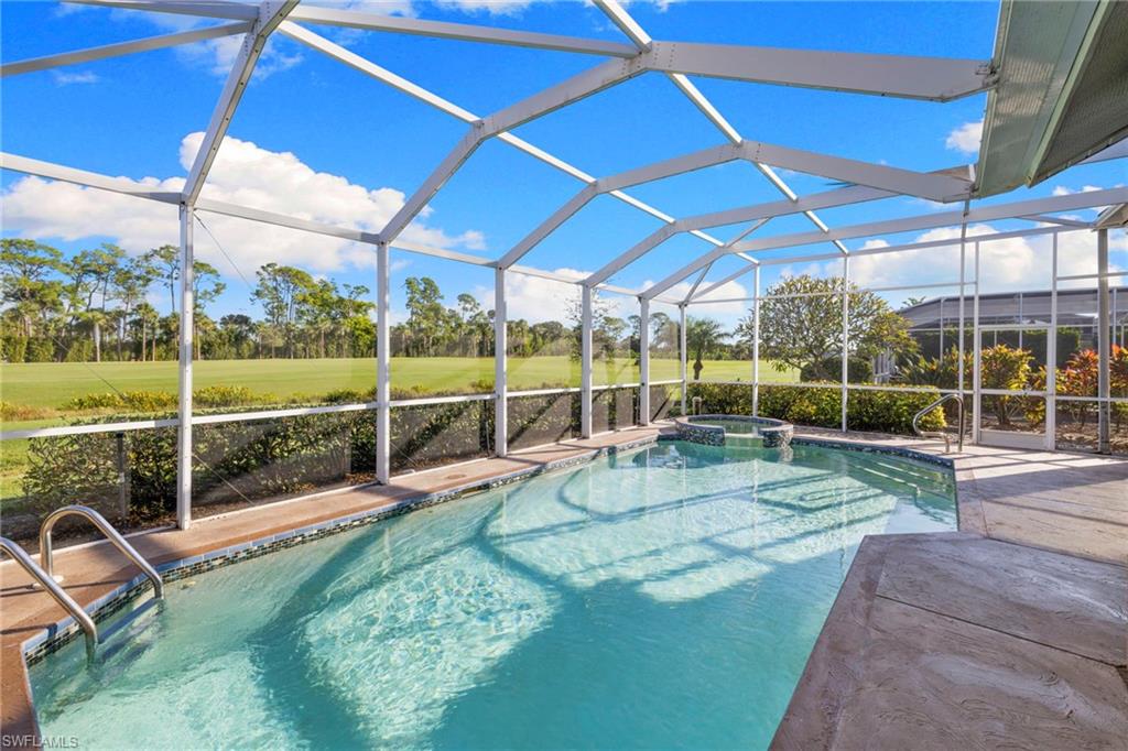 1845 Pondside Lane Naples, FL 34109 - Photo 42 of 47 a view of a backyard with sitting area