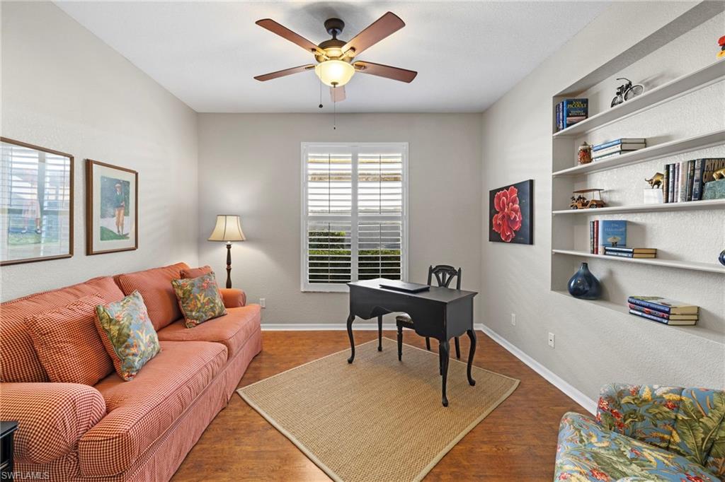 1845 Pondside Lane Naples, FL 34109 - Photo 7 of 47 a living room with furniture and a book shelf