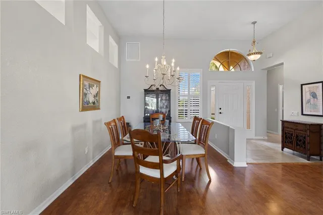 a view of a dining room with furniture wooden floor and chandelier