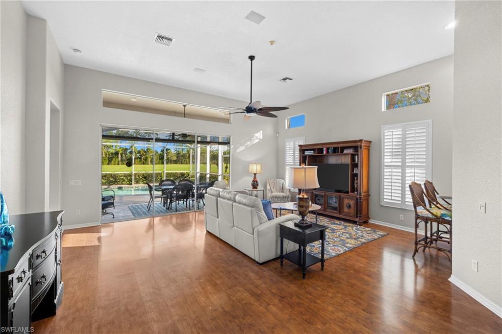 1845 Pondside Lane Naples, FL 34109 - Photo 10 of 47 a living room with furniture a window and a flat screen tv