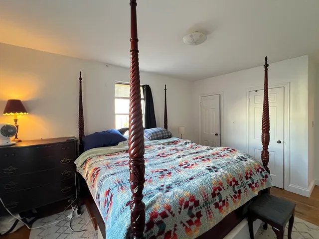 a bed sitting in a bedroom next to a window