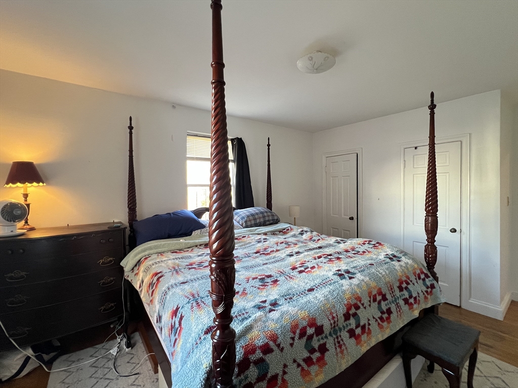 395 Broadway, Unit R2C Cambridge, MA 02139 - Photo 11 of 26 a bed sitting in a bedroom next to a window