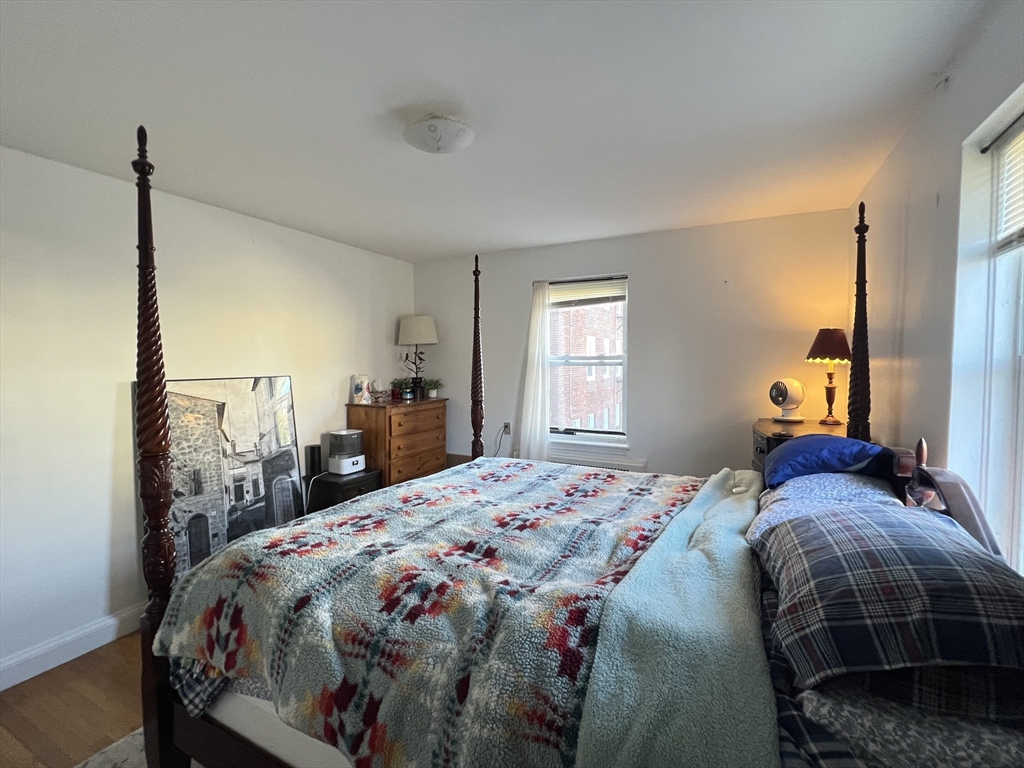 395 Broadway, Unit R2C Cambridge, MA 02139 - Photo 12 of 26 a bedroom with a bed and a window