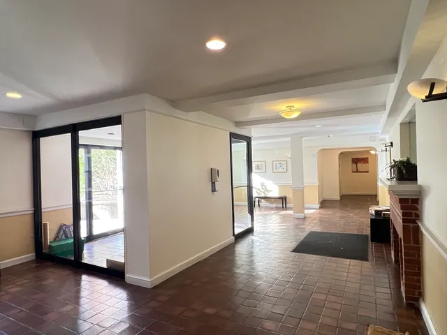 a hallway with a large window and a rug