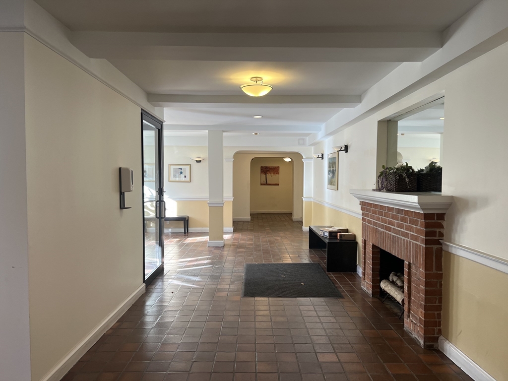 395 Broadway, Unit R2C Cambridge, MA 02139 - Photo 21 of 26 a living room with furniture and a fireplace