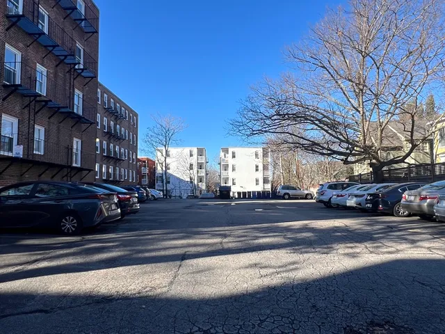 a view of street with parked cars