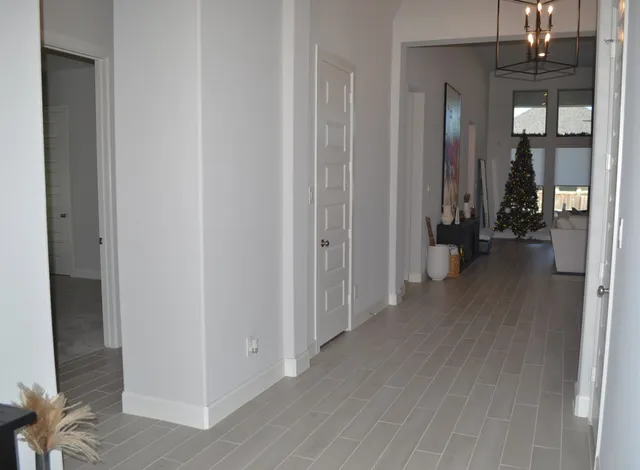 a living room with furniture wooden floor and a large window