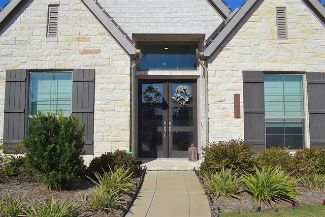 a living room with furniture and large windows