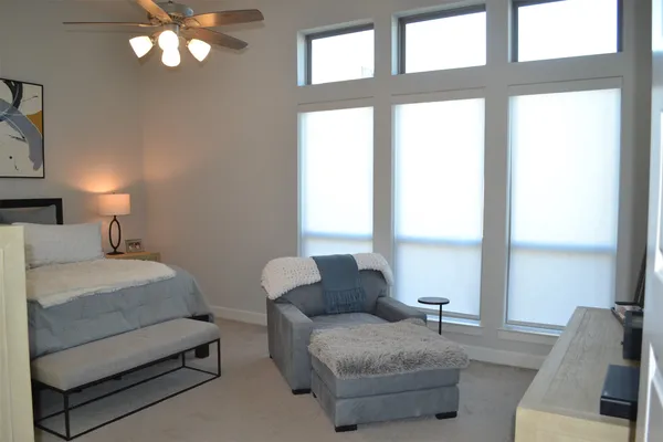 a bedroom with a bed and painting on the wall