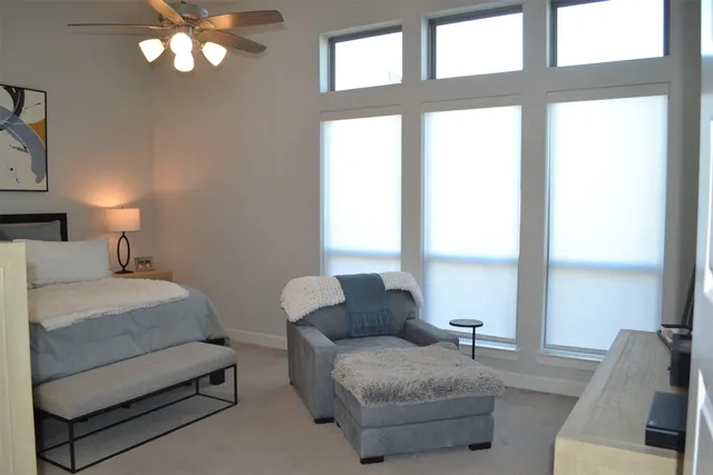 a bedroom with a bed and painting on the wall