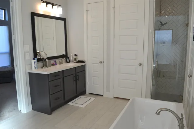 a bathroom with a sink double vanity and a mirror