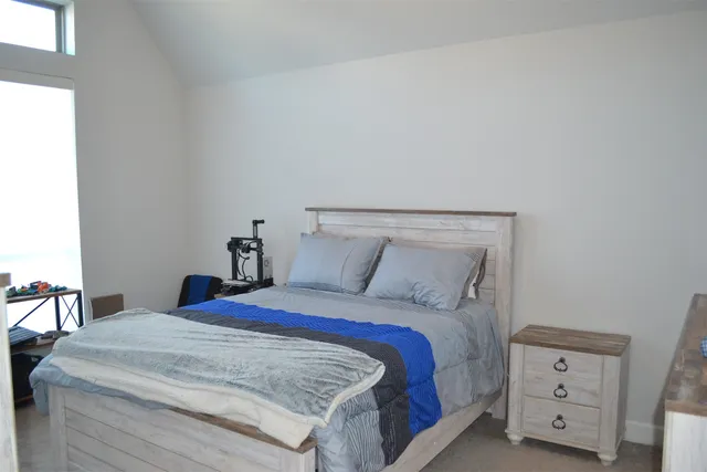 a view of a livingroom with wooden floor cabinet and flat screen tv