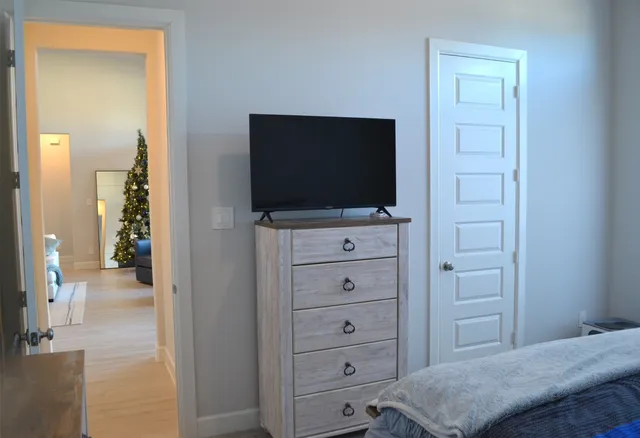 a living room with furniture and a painting on the wall