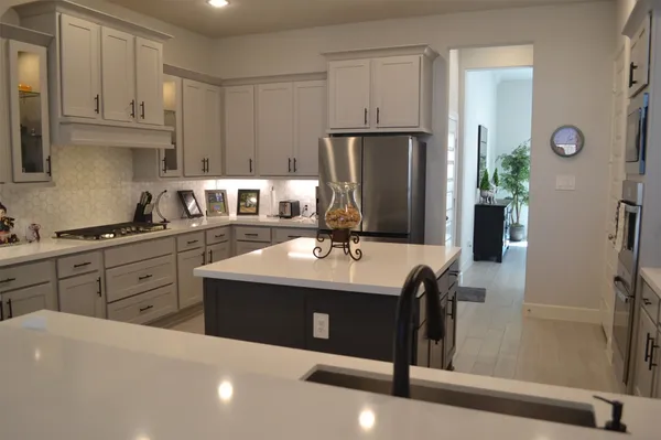 a hallway with a dining table and chairs