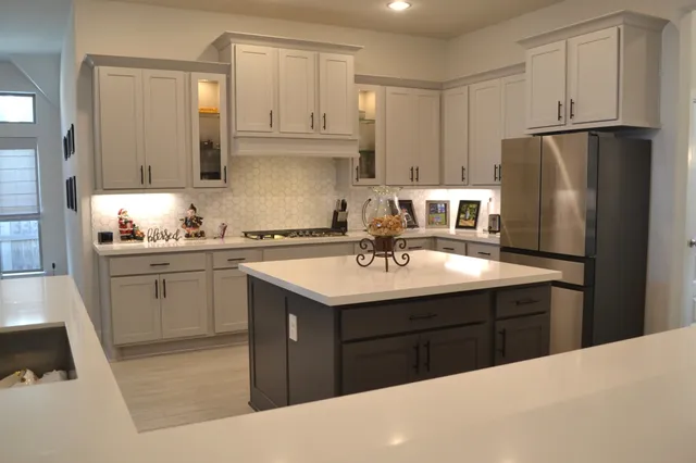 a kitchen with a sink stove and cabinets