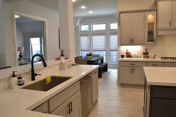 a kitchen with granite countertop cabinets and white appliances