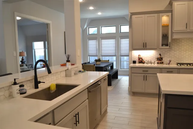 a kitchen with granite countertop cabinets and white appliances