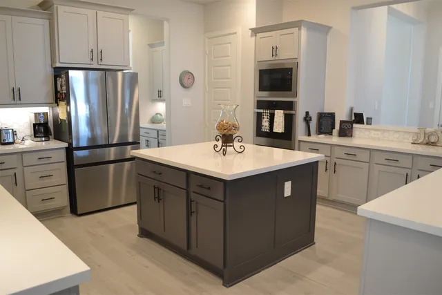 a kitchen with a sink a microwave and cabinets