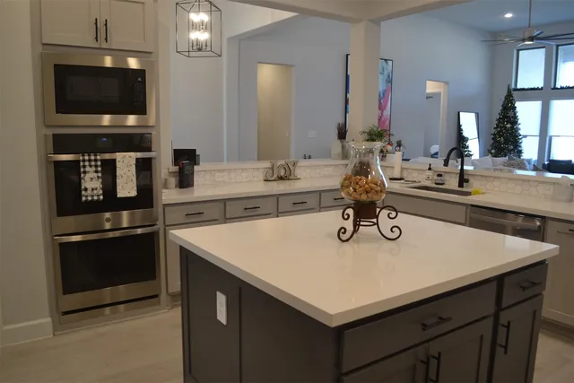 a kitchen with a sink a counter space and stainless steel appliances