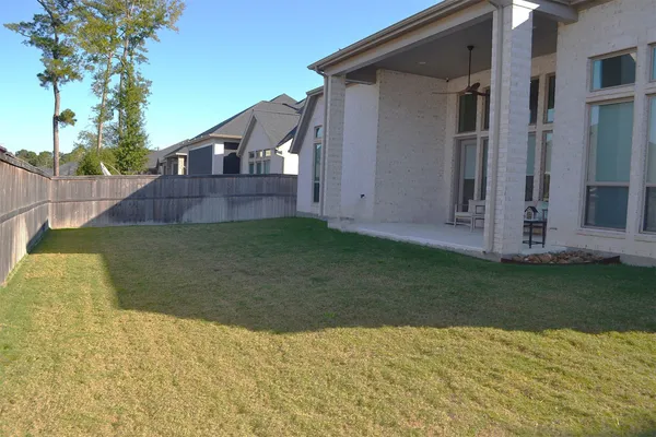 a view of a house with a backyard