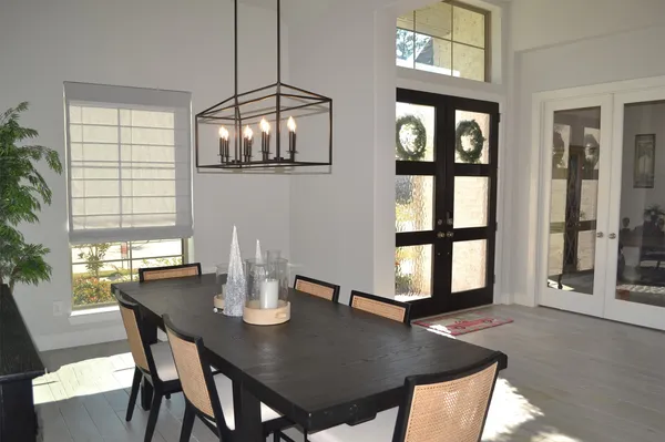 a view of a hallway with a chair and front door