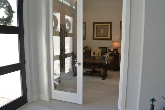 a view of a workspace with furniture and a window