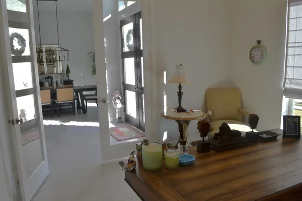 a view of a hallway with bathroom and wooden floor