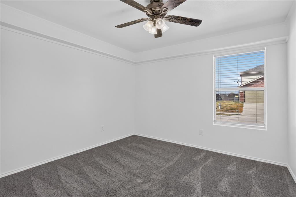 12933 Azure Heights Place Rhome, TX 76078 - Photo 21 of 37 Recessed ceiling with crown molding, window with blinds, ceiling fan with integrated lighting, and gray carpet flooring
