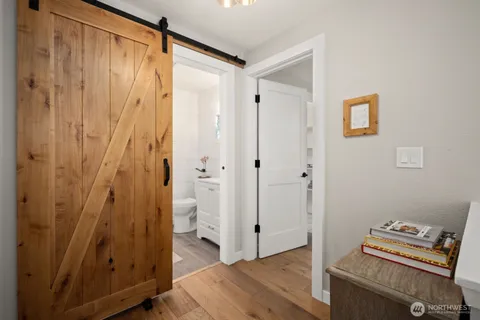 a view of room with wooden floor and bathroom