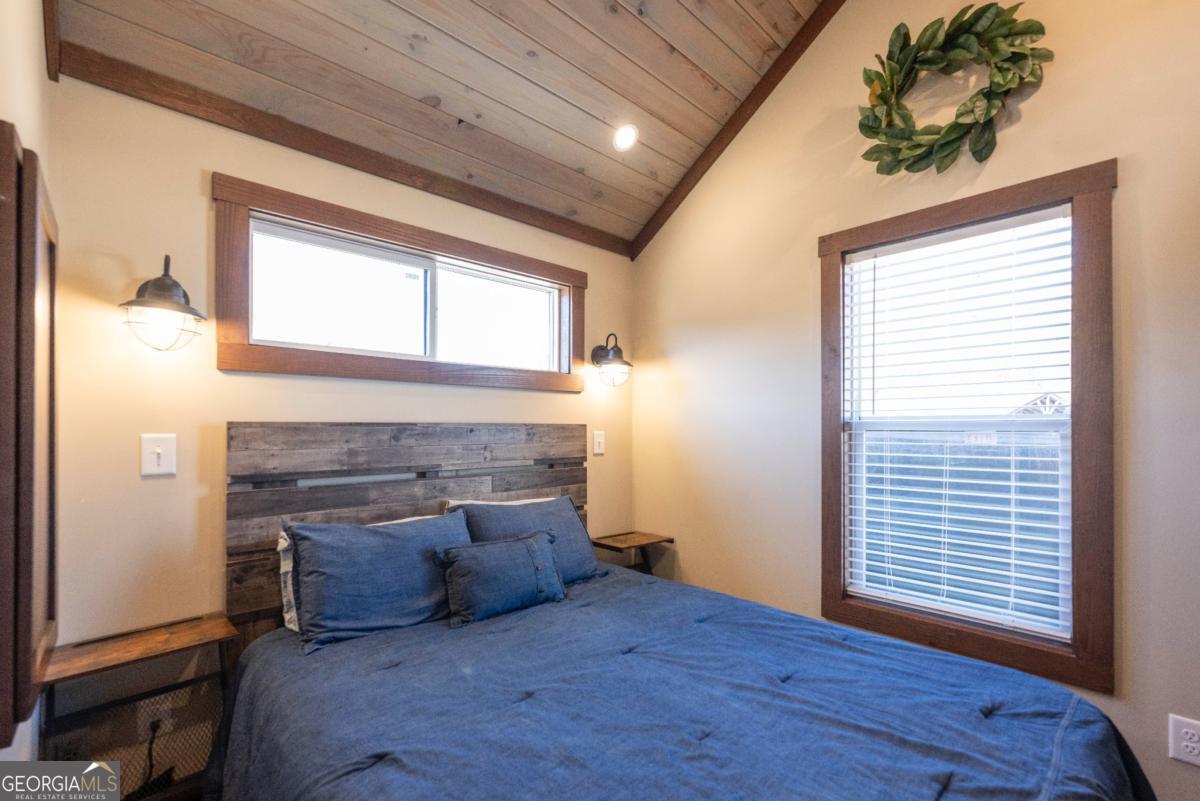 192 Mountain Road Morganton, GA 30560 - Photo 14 of 42 a large bed sitting in a bedroom next to a window and a larger closet